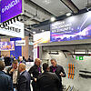 Messestand mit Ausstellungsstücken Tunnel, Messepersonal und Besuchern