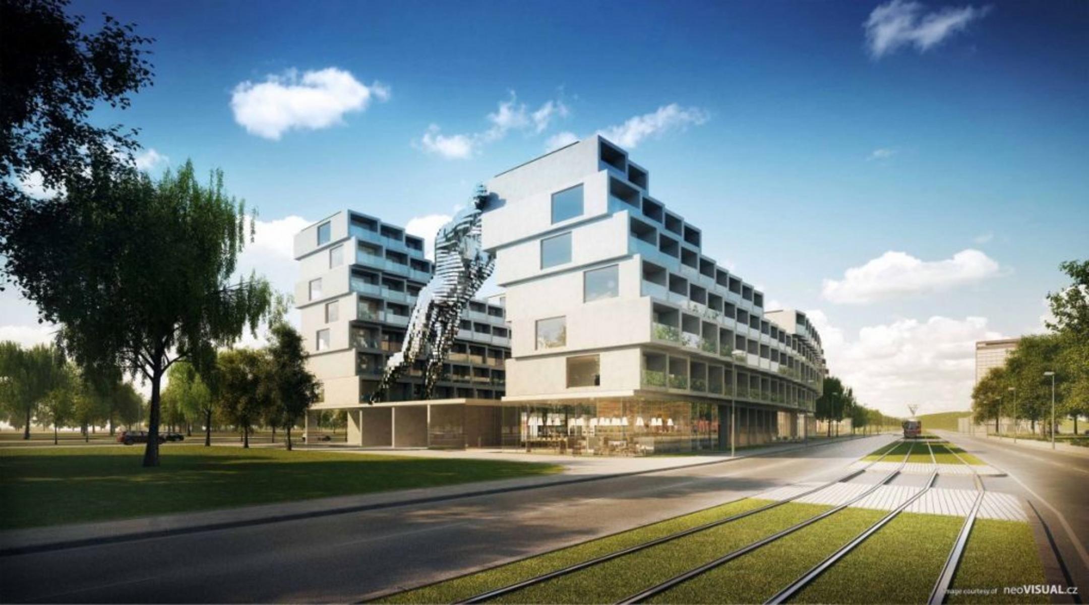 Der stufenartige, moderne Gebäudekomplex vor blauem Himmel, im Vordergrund Grünflächen und Bäume.