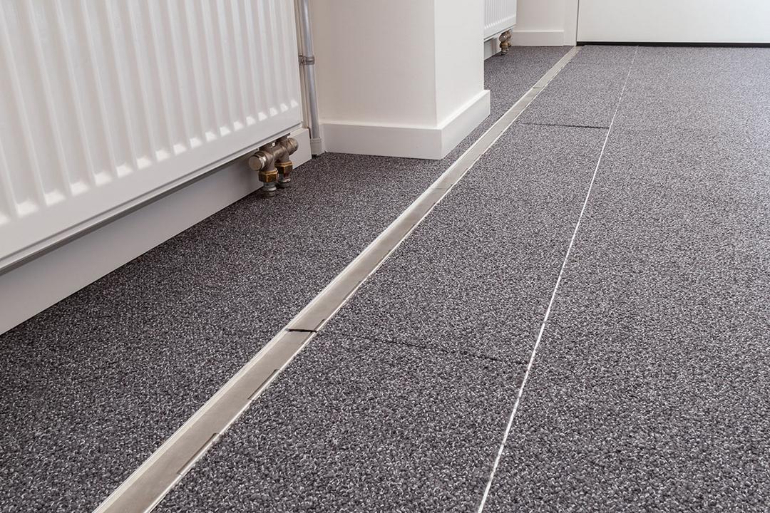 Das in den Boden eingelassene Kanalsystem für Kabel, geschlossen, in einem Büro. Es ist sehr unauffällig.