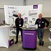 Messestand mit Schriftzug PohlCon und 2 Mitarbeitern sowie Ausstellungsstücken