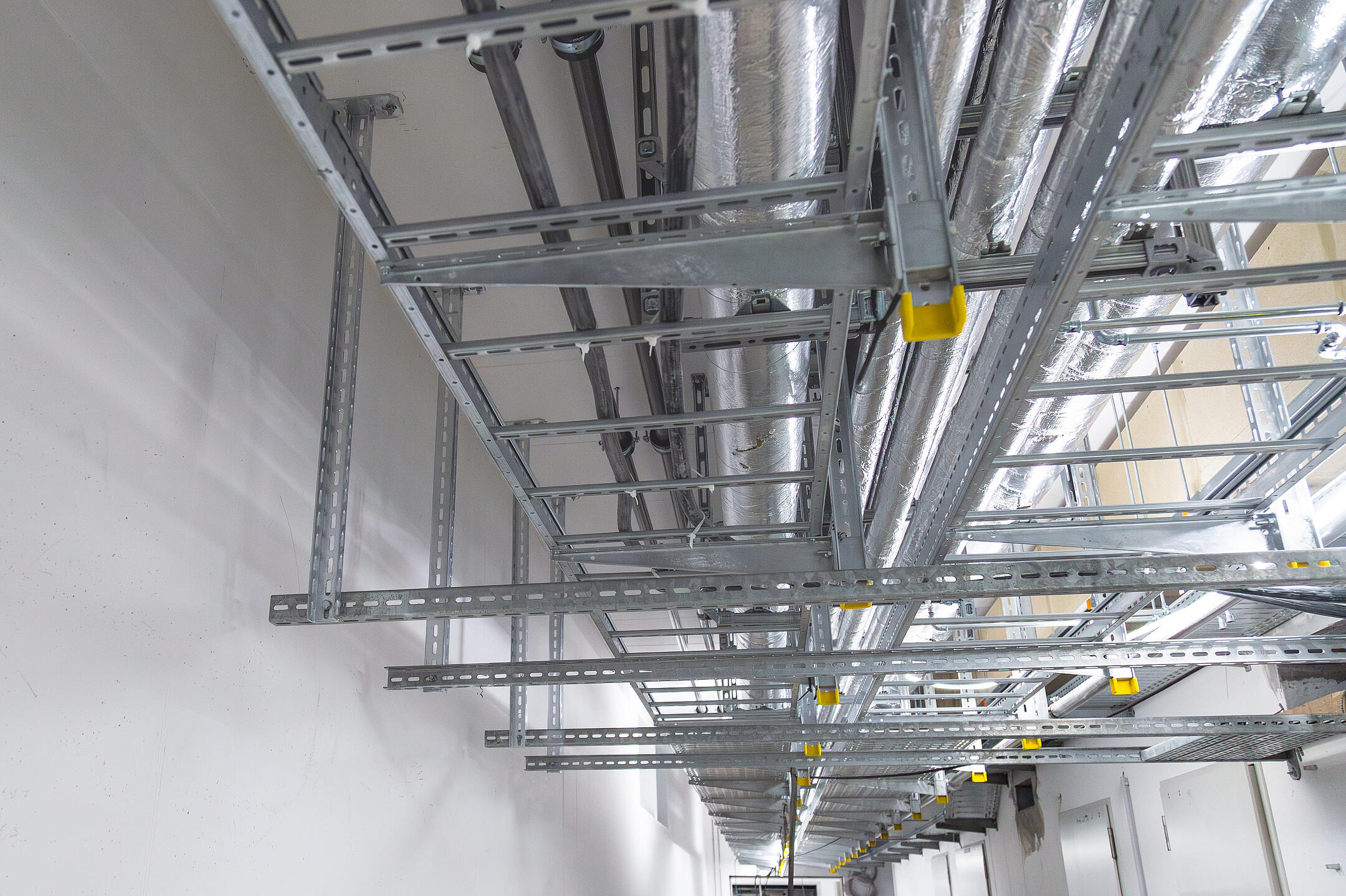 Betonrohbau mit an der Decke montierten Kabeltrassen