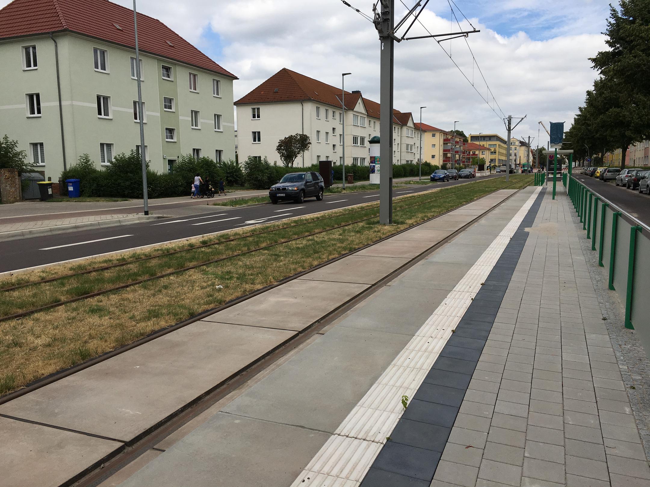 Eine Haltestelle der Magdeburger Straßenbahn mit blauem Himmel im Hintergrund.