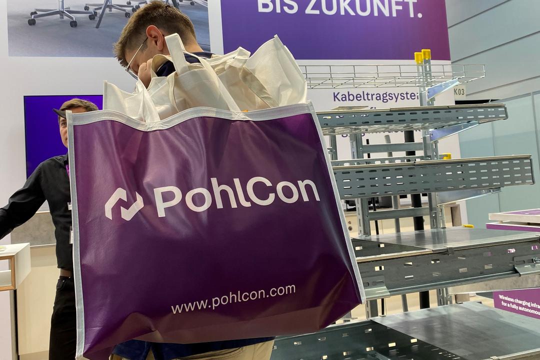 PohlCon-Messestand mit Publikumsverkehr, Mann mit großer Tasche
